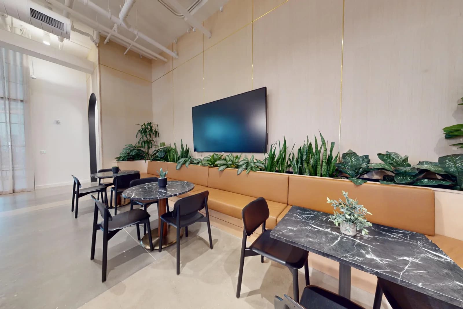 WellSuite lounge banquette with biophilic plant wall